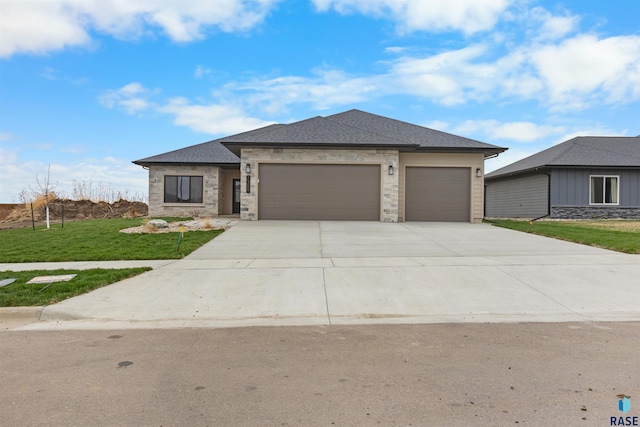 prairie-style home with a garage and a front yard