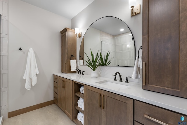 7309 E Shadow Pine Cir, Sioux Falls, SD 57110 - bathroom with tiled shower, double vanity, and baseboards