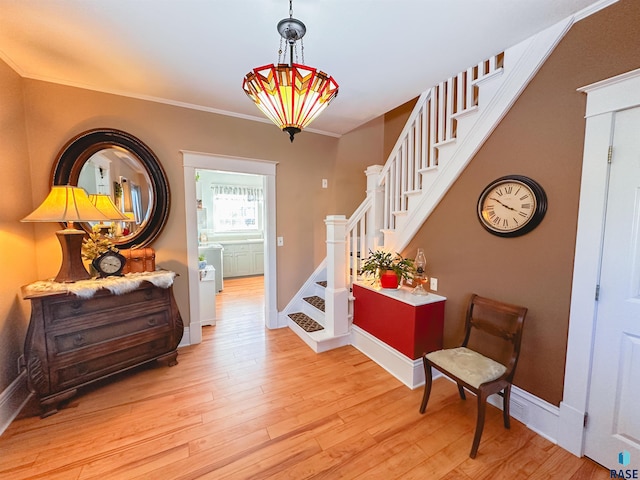 foyer featuring light hardwood / wood-style flooring and crown molding