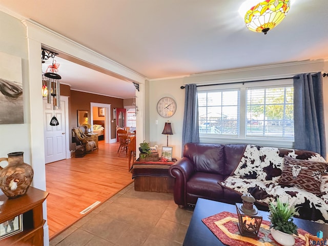 living room featuring hardwood / wood-style flooring and ornamental molding