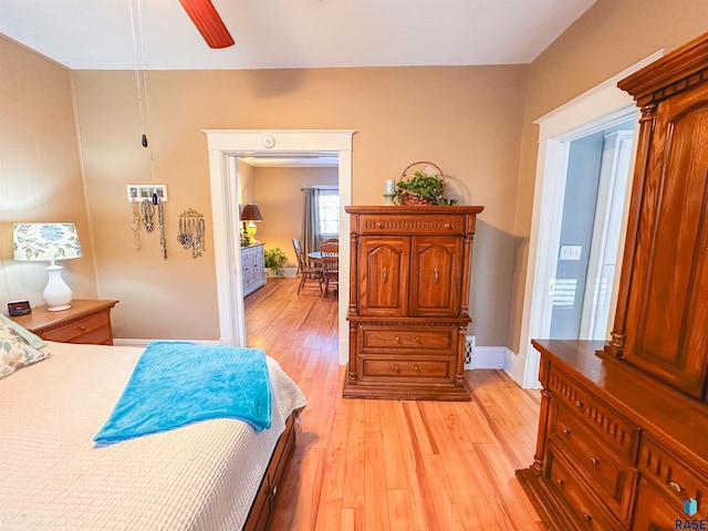 bedroom with ceiling fan and light hardwood / wood-style flooring