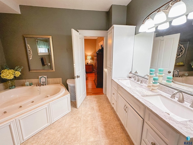 bathroom featuring a bathing tub, tile patterned flooring, and vanity