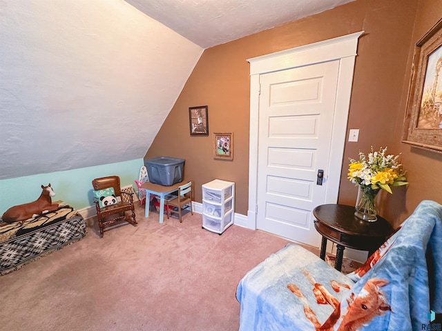 recreation room featuring carpet floors and vaulted ceiling