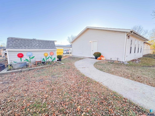 view of home's exterior with a storage unit