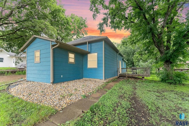 property exterior at dusk with a deck