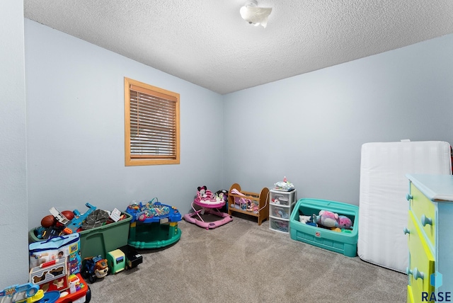 rec room with carpet flooring and a textured ceiling