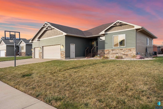 craftsman house featuring a garage and a yard