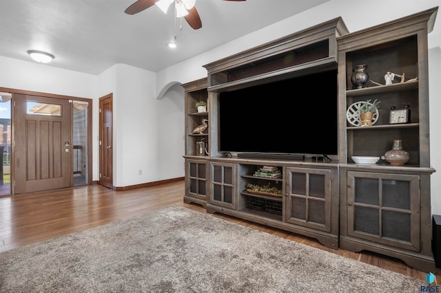 living room with hardwood / wood-style flooring and ceiling fan