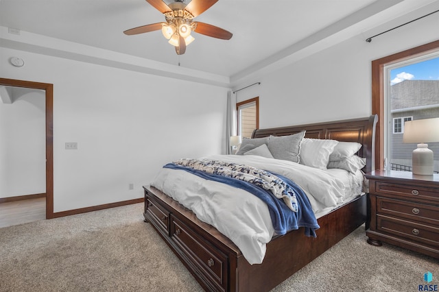 bedroom with ceiling fan and light colored carpet