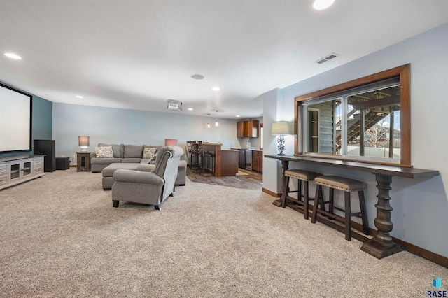 carpeted living room with bar area