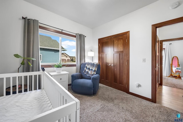 bedroom featuring hardwood / wood-style floors and a nursery area