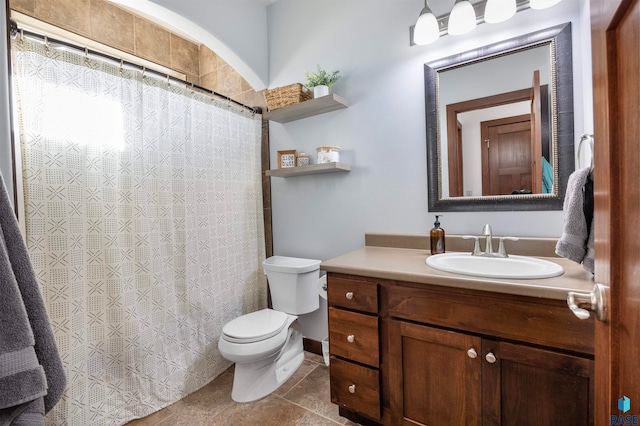 bathroom featuring toilet, vanity, and tile patterned floors