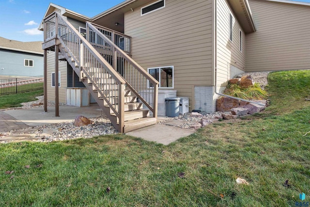 rear view of house featuring a lawn, a patio area, and a deck