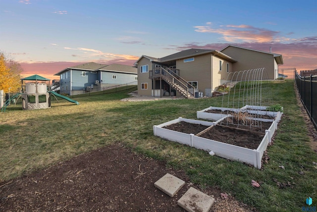 yard at dusk with a playground and central AC