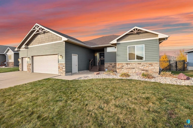 craftsman-style home featuring a garage and a yard