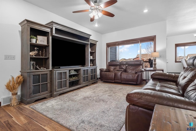 living room featuring hardwood / wood-style floors and ceiling fan