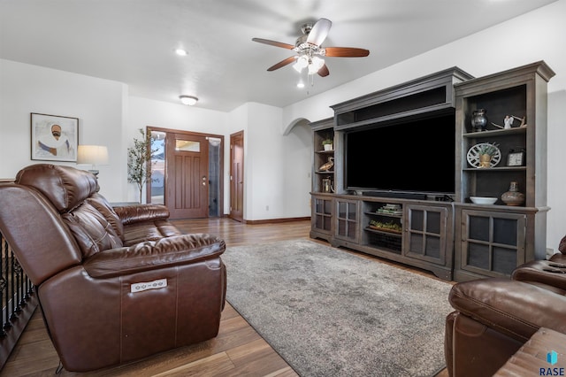 living room featuring hardwood / wood-style flooring and ceiling fan