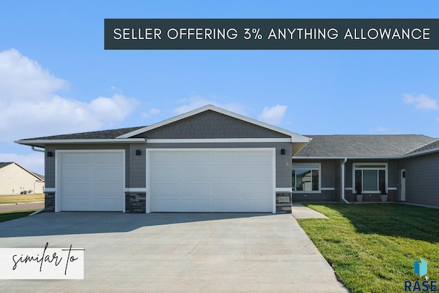 view of front of property featuring a garage and a front yard