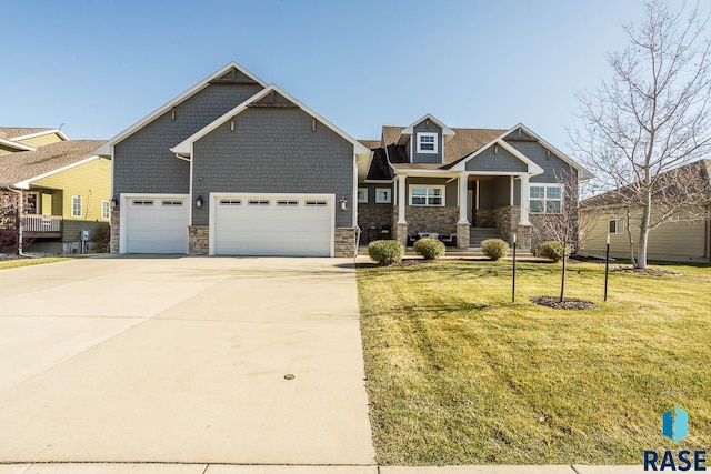 craftsman inspired home featuring a garage, a porch, and a front yard