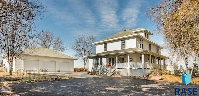 farmhouse inspired home featuring a garage and a porch