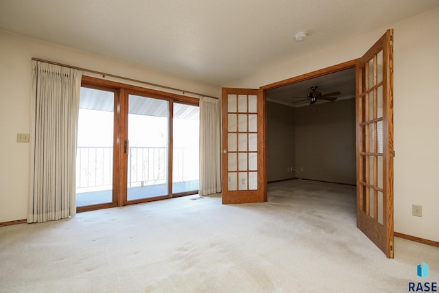 unfurnished room featuring light carpet, french doors, and ceiling fan