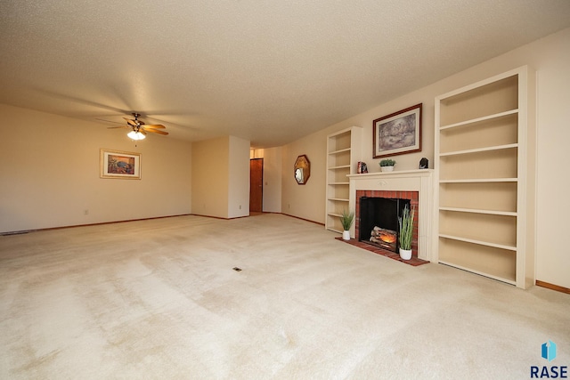 unfurnished living room with carpet flooring, built in shelves, a textured ceiling, ceiling fan, and a fireplace