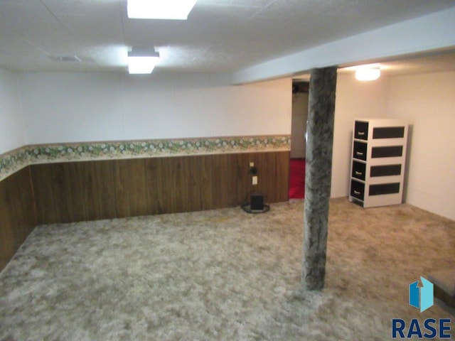 basement featuring light colored carpet