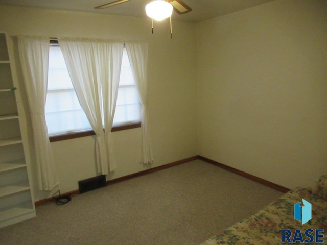 empty room with carpet and ceiling fan