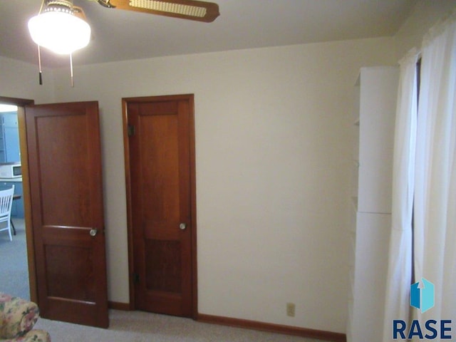 unfurnished bedroom featuring light carpet