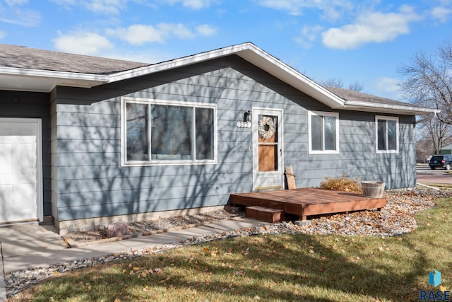 view of front of home with a front yard and a wooden deck