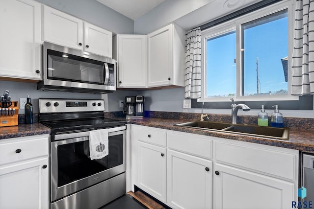 kitchen with white cabinets, sink, and appliances with stainless steel finishes