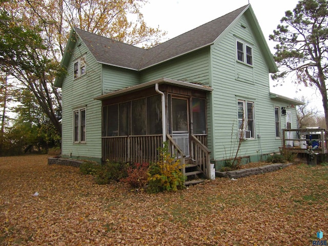 view of front of home with cooling unit and a sunroom