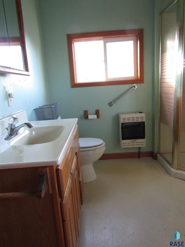 bathroom with plenty of natural light, vanity, toilet, and heating unit