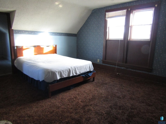 carpeted bedroom with lofted ceiling