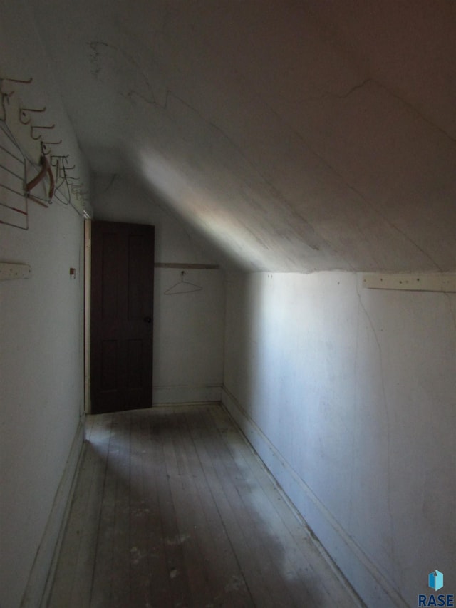 bonus room with lofted ceiling and hardwood / wood-style floors