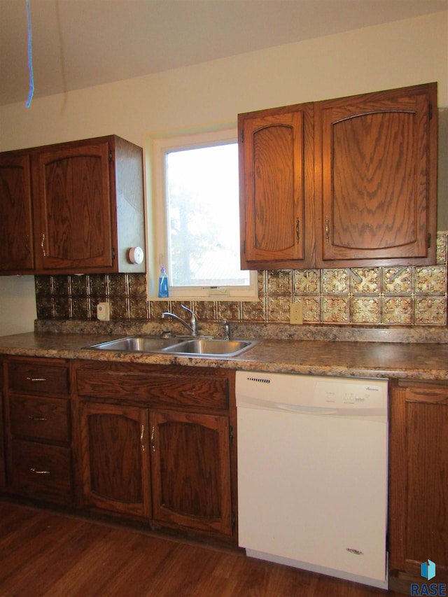 kitchen with white dishwasher, sink, dark hardwood / wood-style flooring, and tasteful backsplash