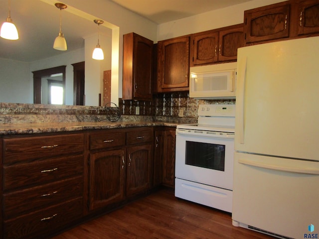 kitchen featuring tasteful backsplash, white appliances, dark hardwood / wood-style floors, and hanging light fixtures