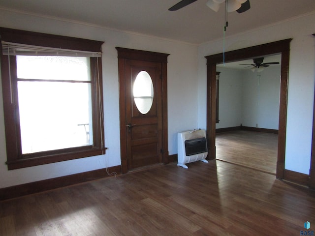 entryway featuring a wealth of natural light, heating unit, and dark hardwood / wood-style flooring