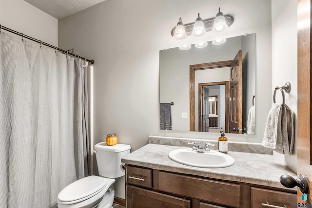 bathroom with toilet and vanity