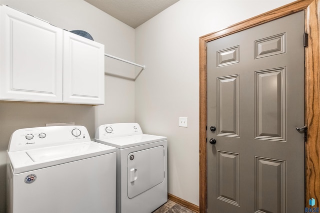 laundry area featuring a textured ceiling, cabinets, and washer and dryer