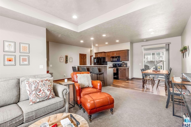 living room featuring light hardwood / wood-style floors and a textured ceiling