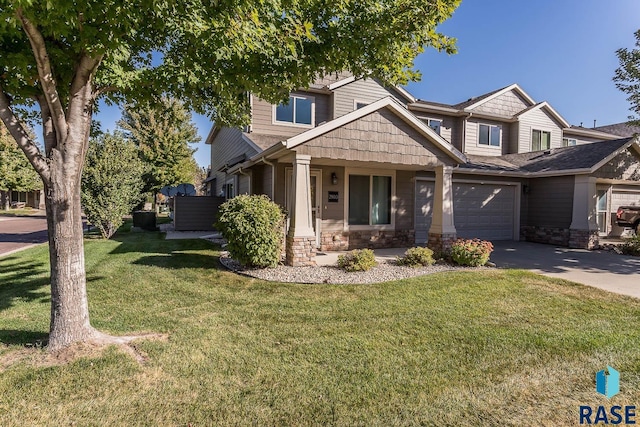 craftsman-style home with a front lawn and a garage