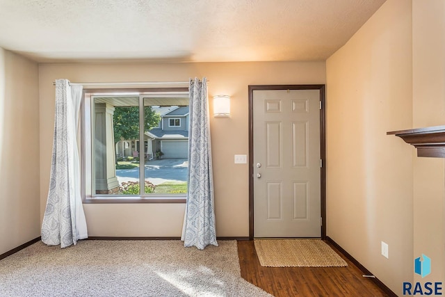 entrance foyer featuring hardwood / wood-style floors and a textured ceiling