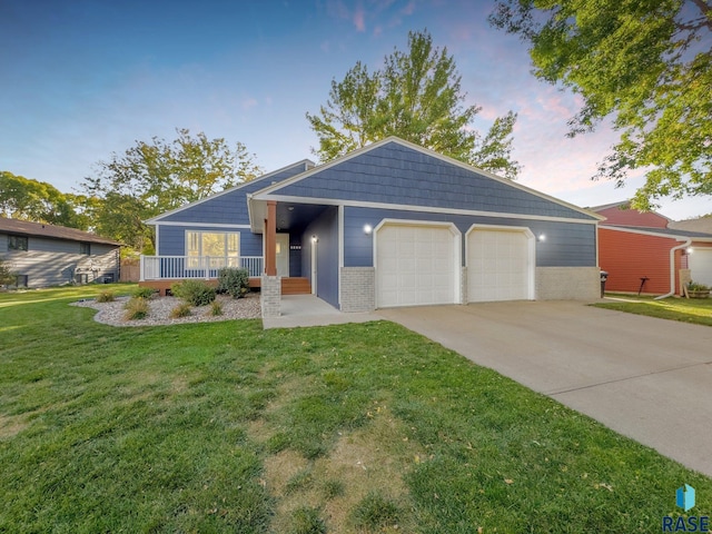 ranch-style house with a garage, a lawn, and a porch