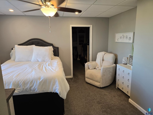 carpeted bedroom with ceiling fan, a closet, and a spacious closet