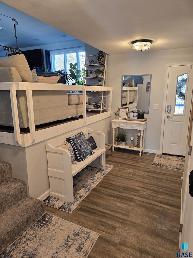 bedroom with dark hardwood / wood-style flooring