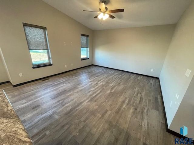 empty room featuring hardwood / wood-style flooring, ceiling fan, and lofted ceiling