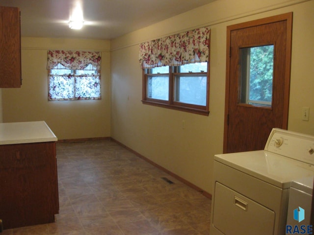 laundry room featuring cabinets and washer and dryer