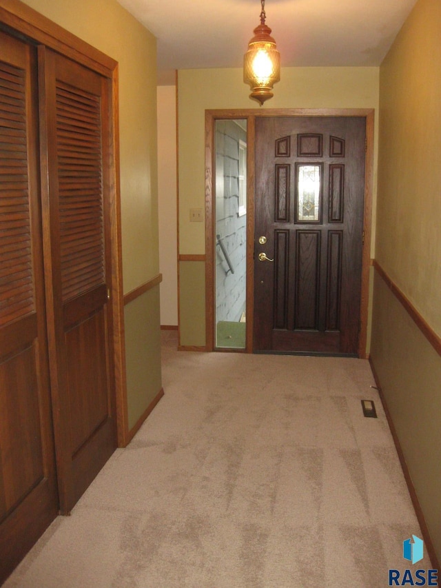 foyer entrance with light colored carpet