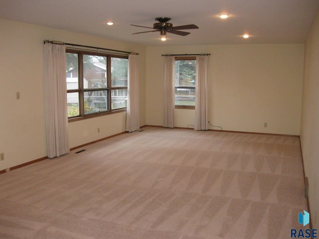 empty room with light carpet and ceiling fan